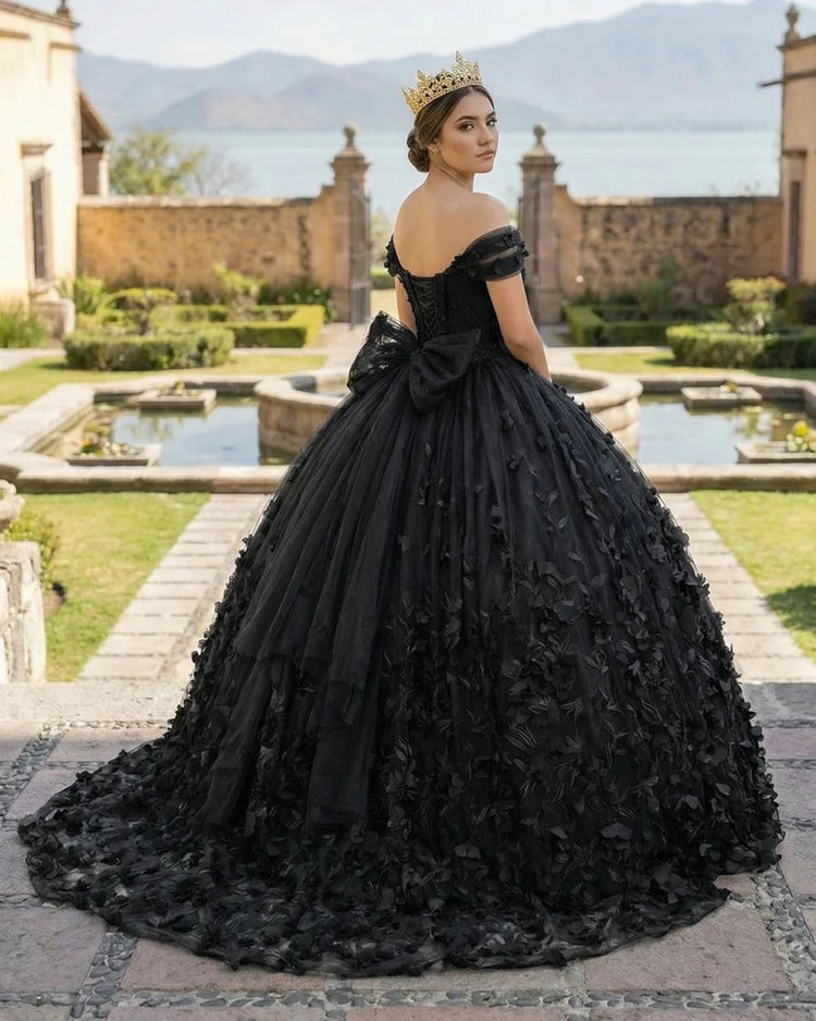black ball gown quince dress with a large bow and floral details