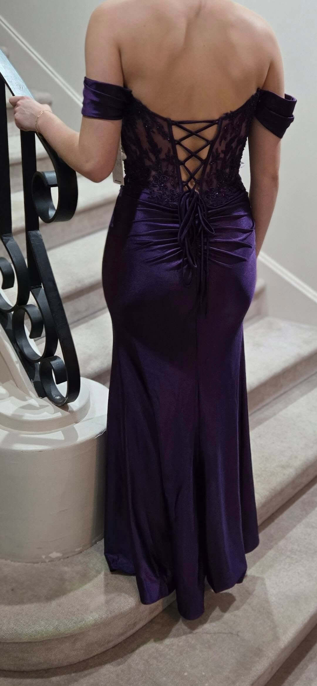 deep purple off-the-shoulder evening gown with a lace-up open back