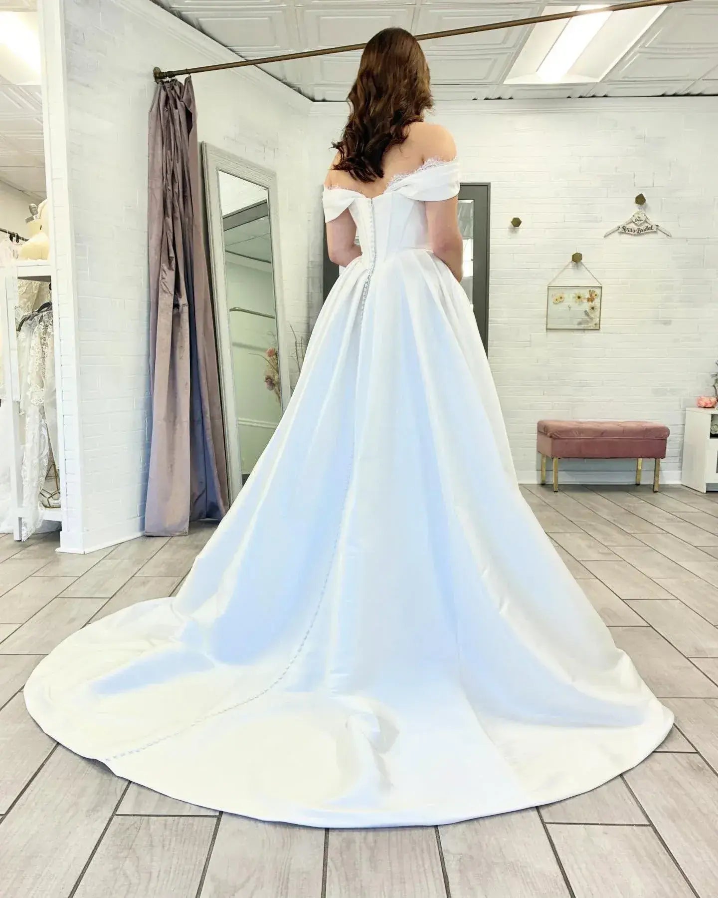 white off-shoulder satin wedding gown