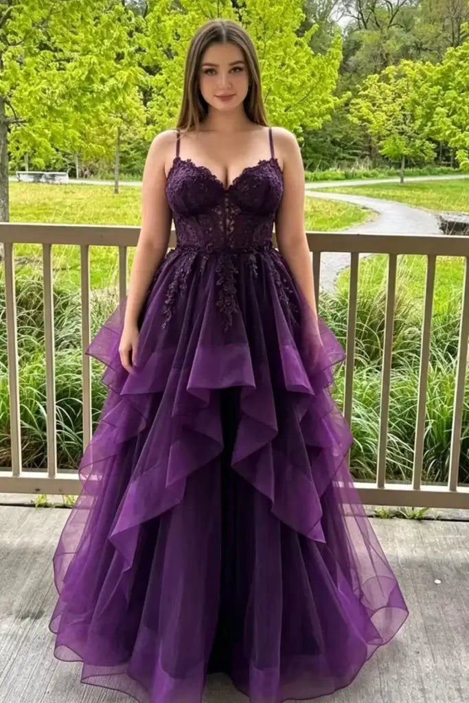  formal purple gown with lace-embroidered bodice, thin straps, and a layered tulle skirt.