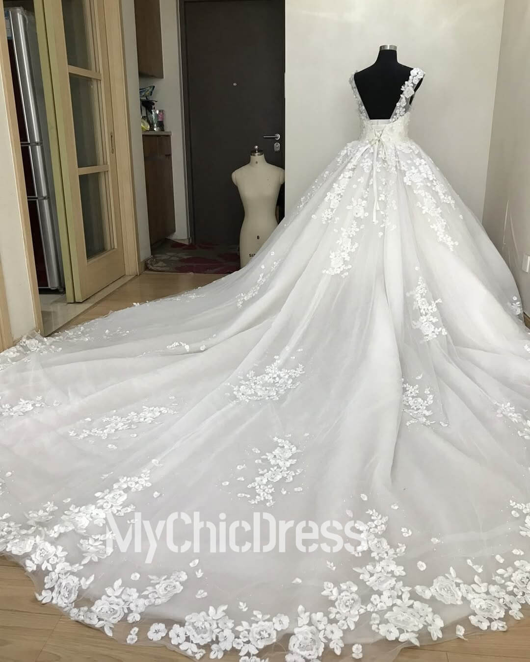 white ballgown wedding dress with intricate floral lace appliques