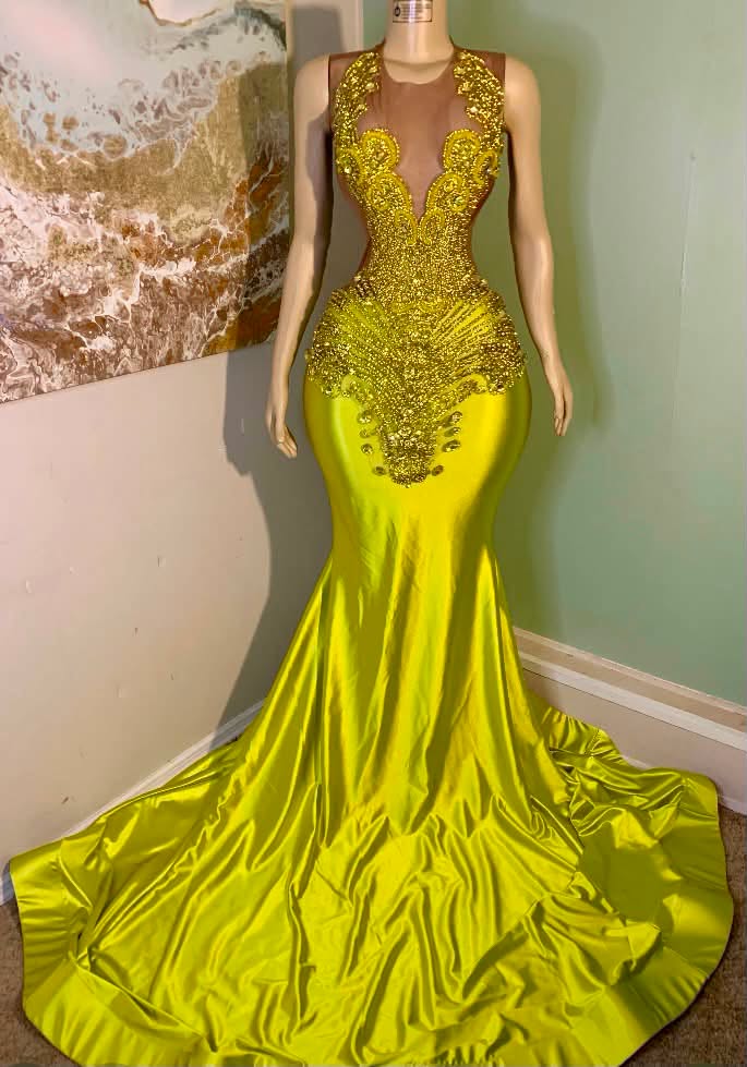 A bright green formal gown with gold beaded embellishments and a sheer mesh bodice