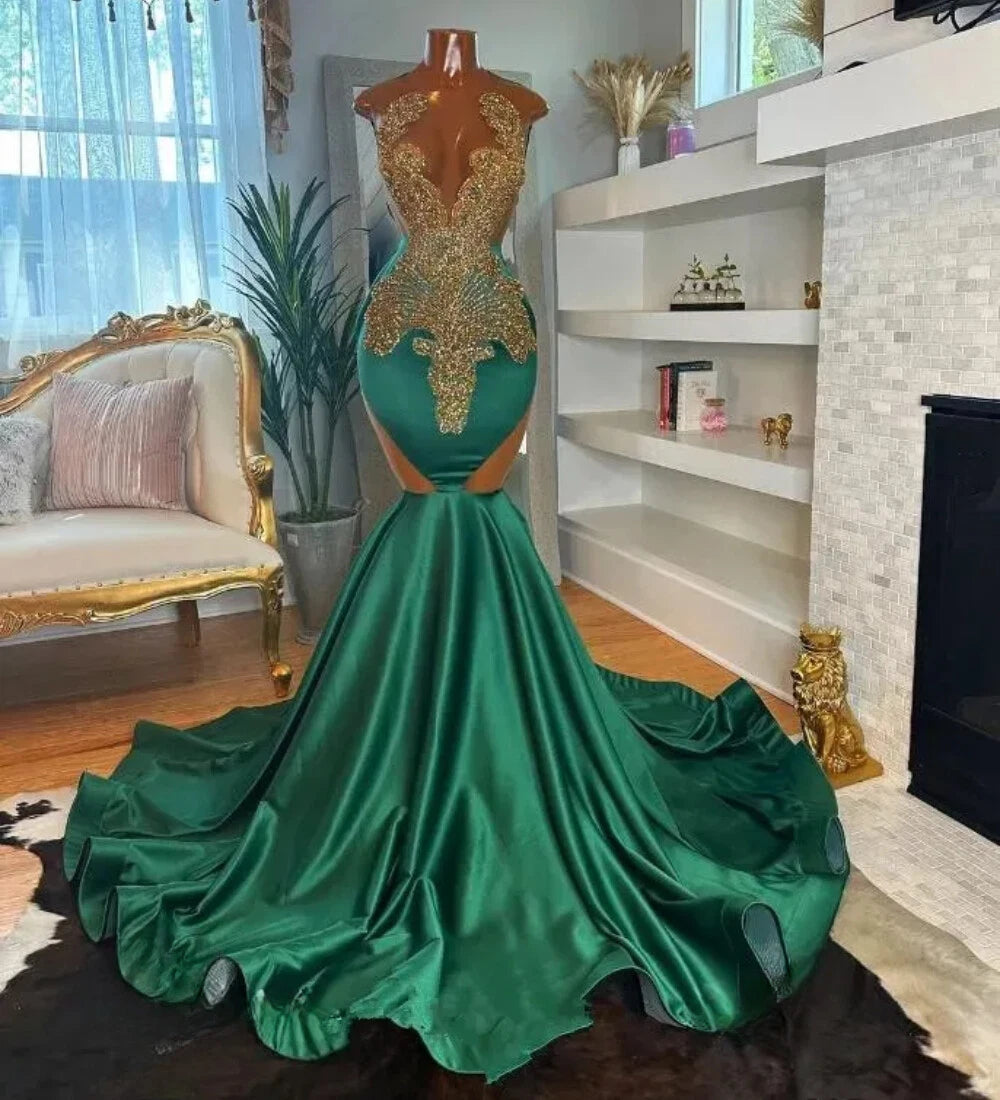A formal mermaid gown in rich emerald green satin with ornate gold lace applique on the bodice