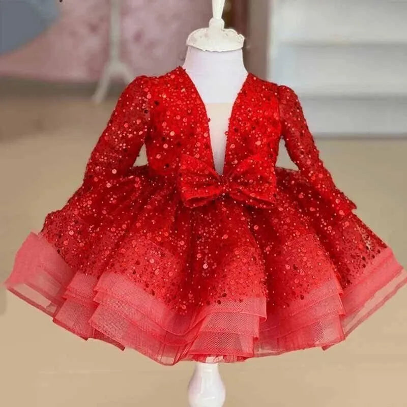 A red long-sleeve toddler party dress with sequins and a ruffled tulle skirt