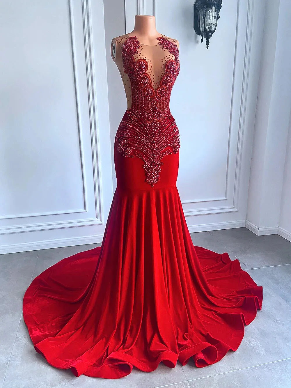 Red evening gown with intricate beading on a mannequin