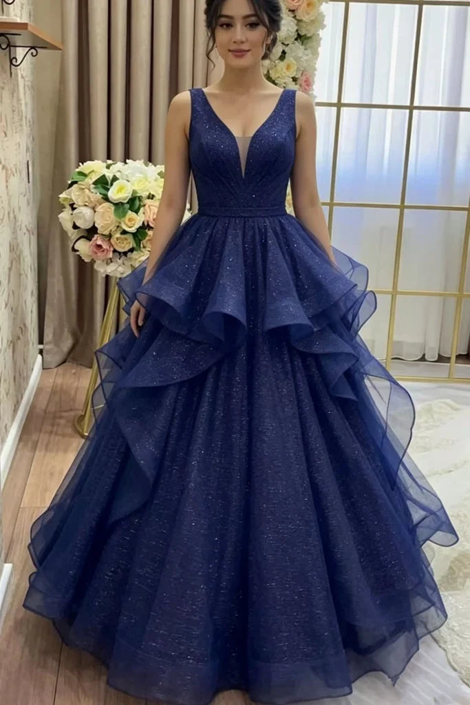sparkling navy blue ball gown with a deep V-neckline and tiered ruffle skirt