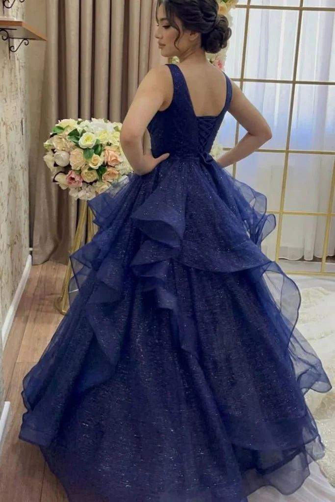 sparkling navy blue ball gown with a deep V-neckline and tiered ruffle skirt