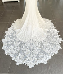 Close-up of a white lace wedding dress