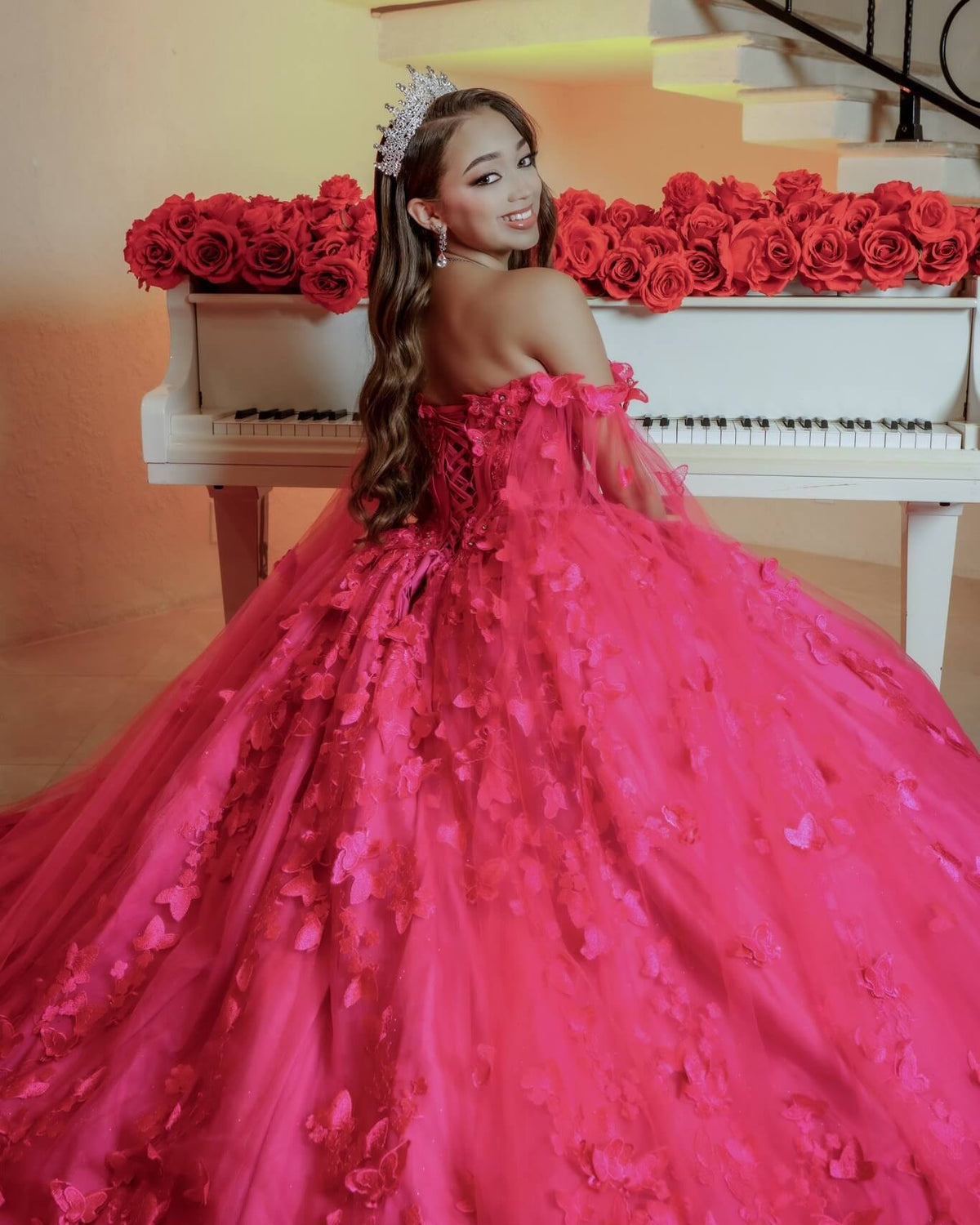 bright pink off-the-shoulder ball gown with 3D floral appliqués and a matching crown