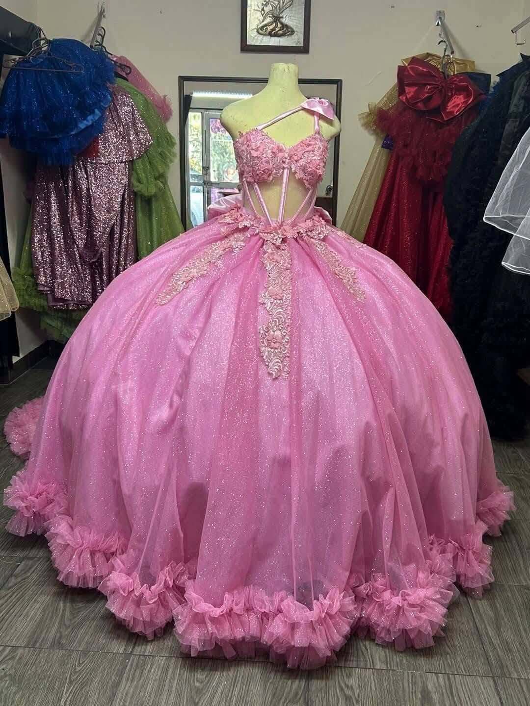 pink ball gown sweetheart bodice, lace applique, and ruffled tulle hem