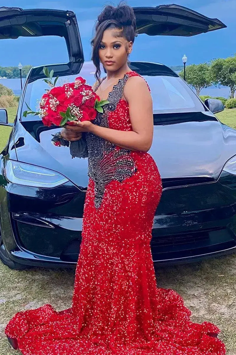  sleeveless red evening gown covered in sequins and beads