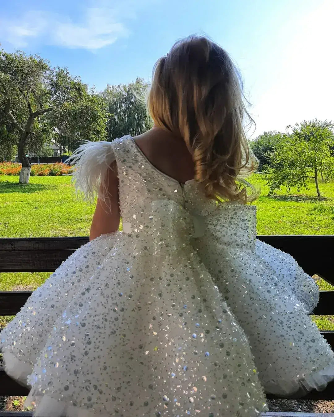 sparkling white dress with feathered sleeves